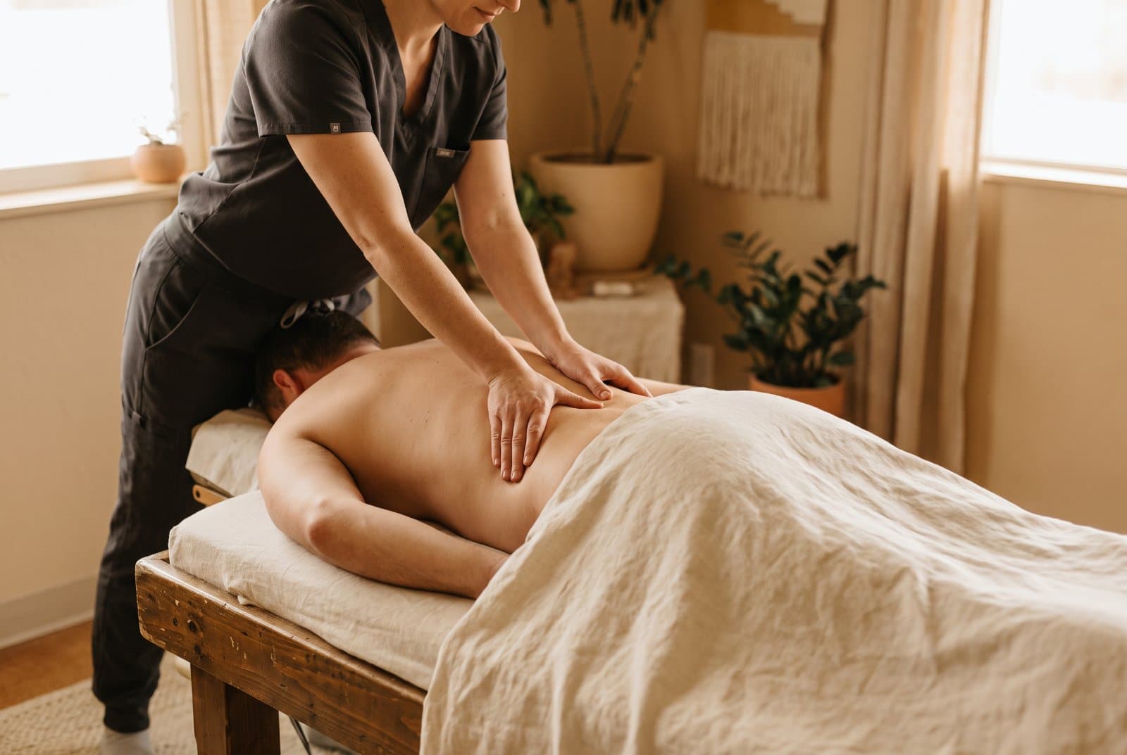 Hands-on lower-back treatment on a treatment table